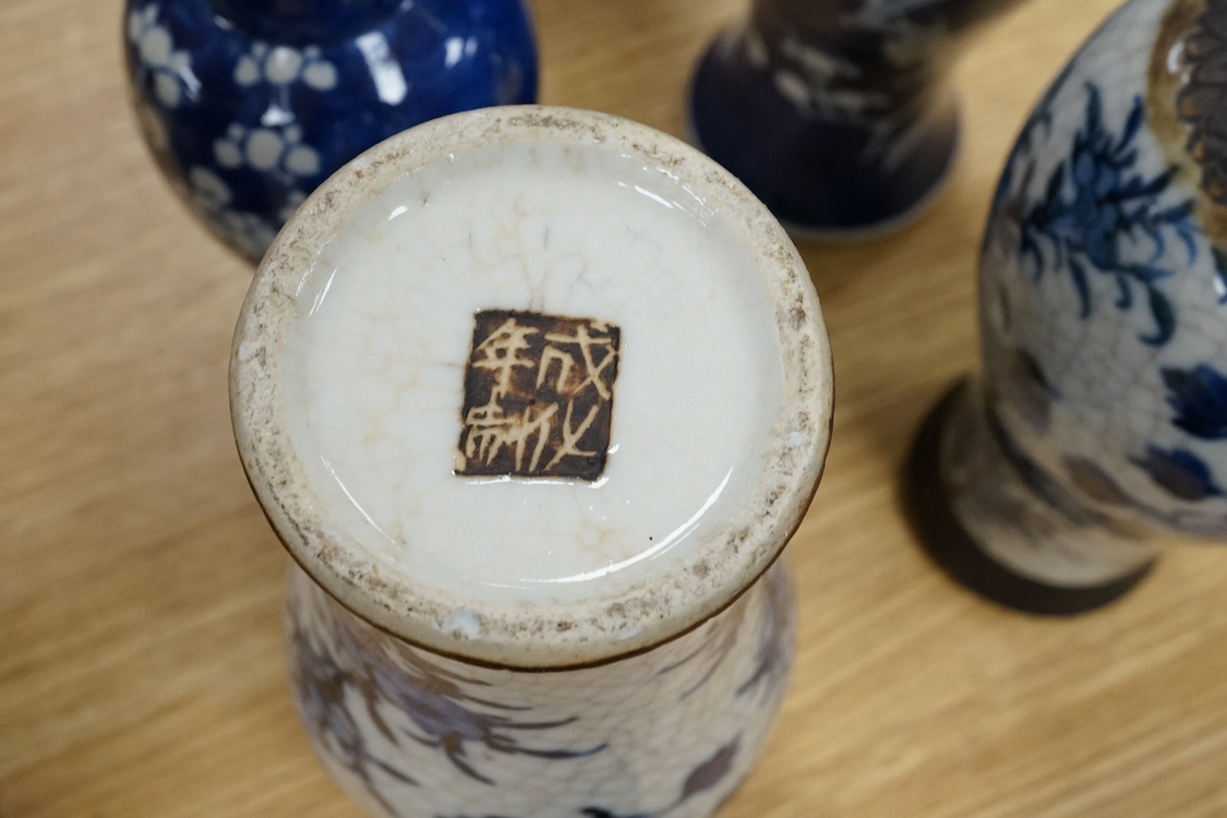Chinese blue and white porcelain, late 19th century, comprising two prunus vases, two crackle glaze vases and a 'Bird and Flowers' jar, tallest crackle glaze vases 23cm